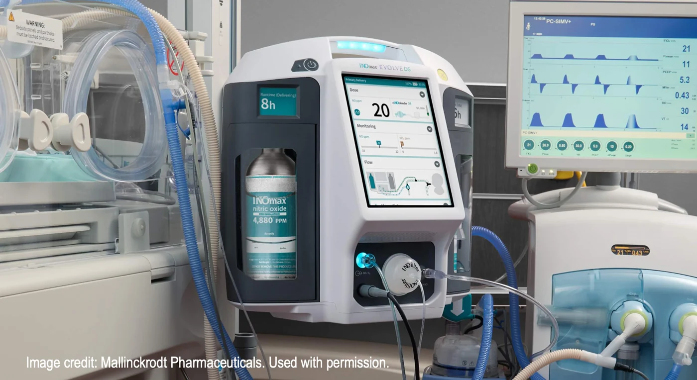 INOmax EVOLVE DS delivery system beside hospital equipment, showing its touchscreen and cylinder enclosure